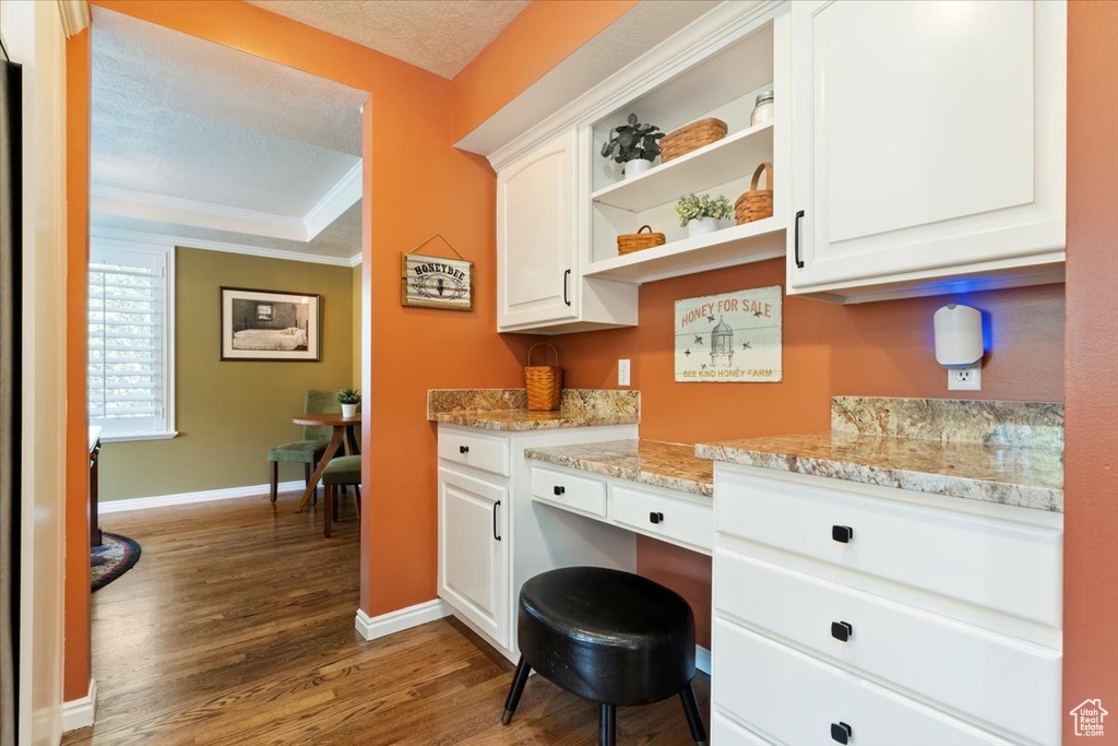 Office area featuring wood finished floors and crown molding