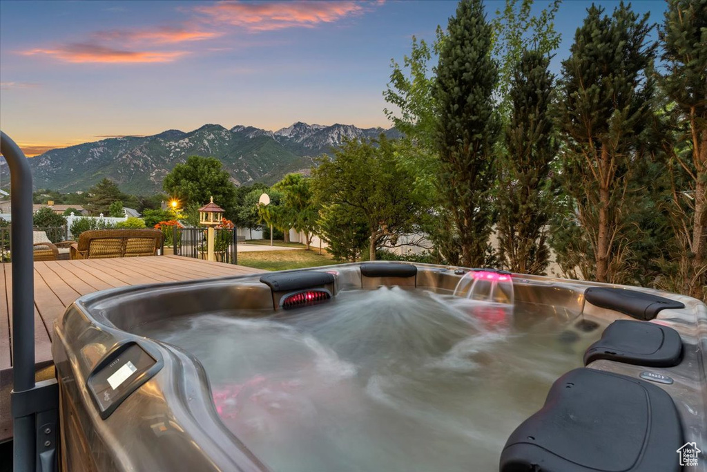 Exterior space featuring a jacuzzi and a deck with mountain view