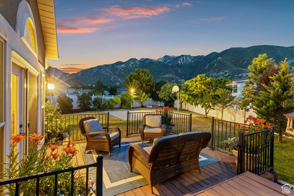 Deck with outdoor lounge area and a mountain view