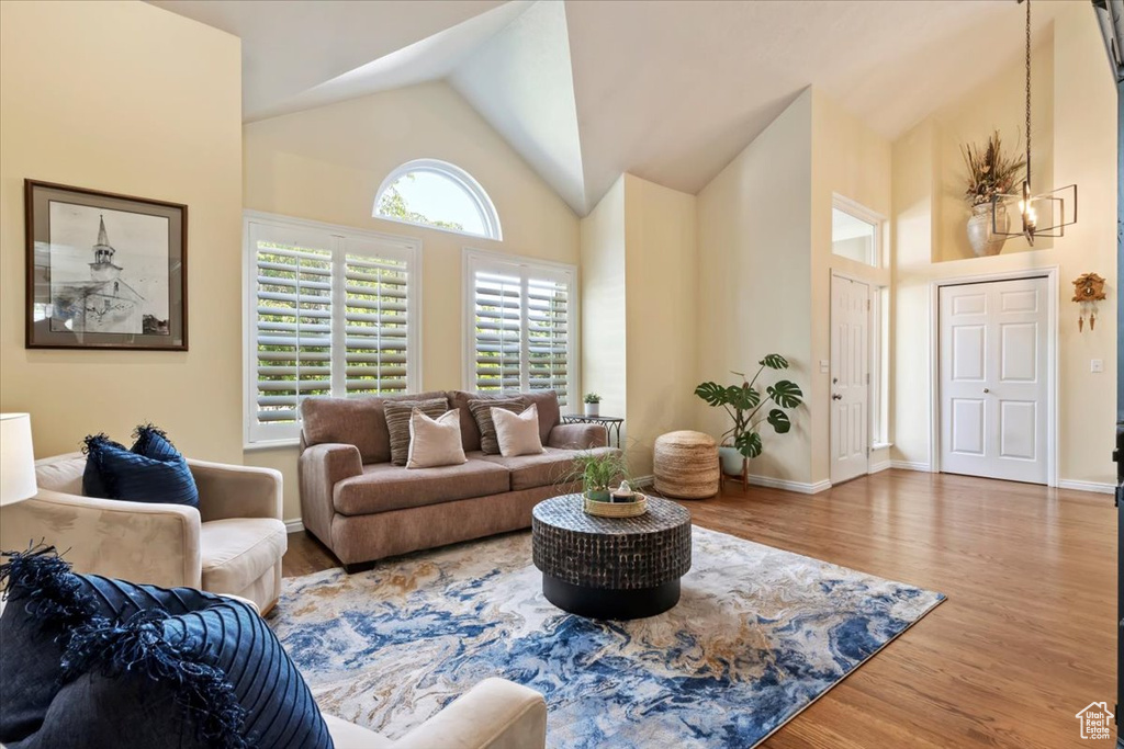 Living room with wood finished floors and high vaulted ceiling