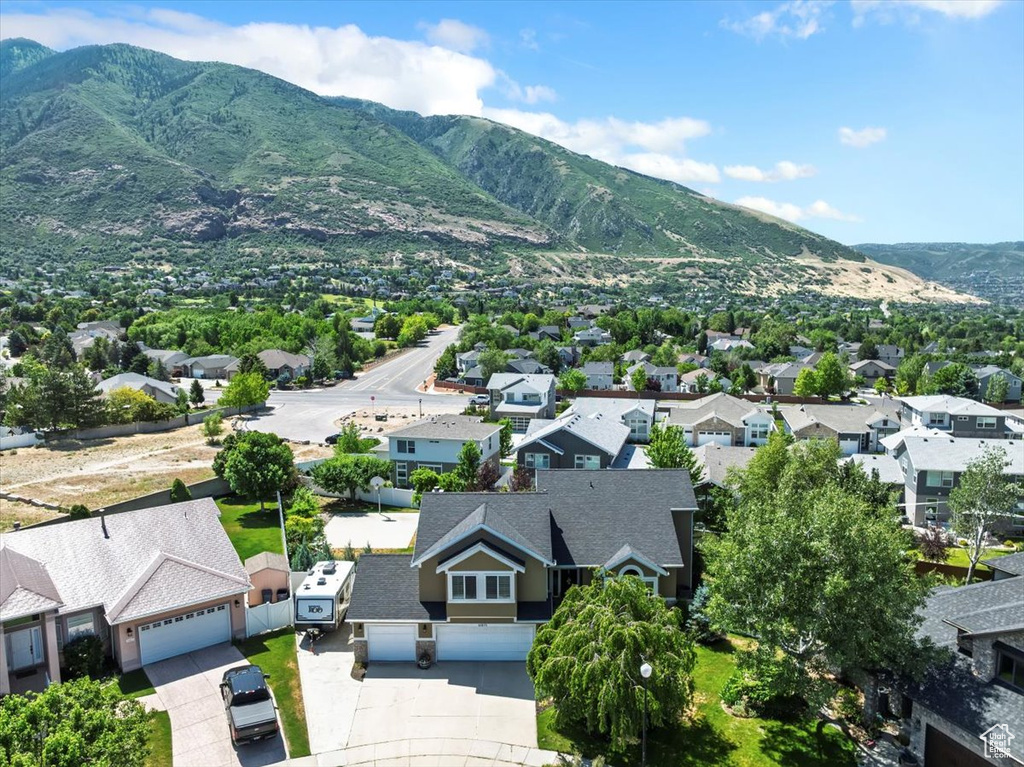 Aerial view of residential area featuring a mountainous background