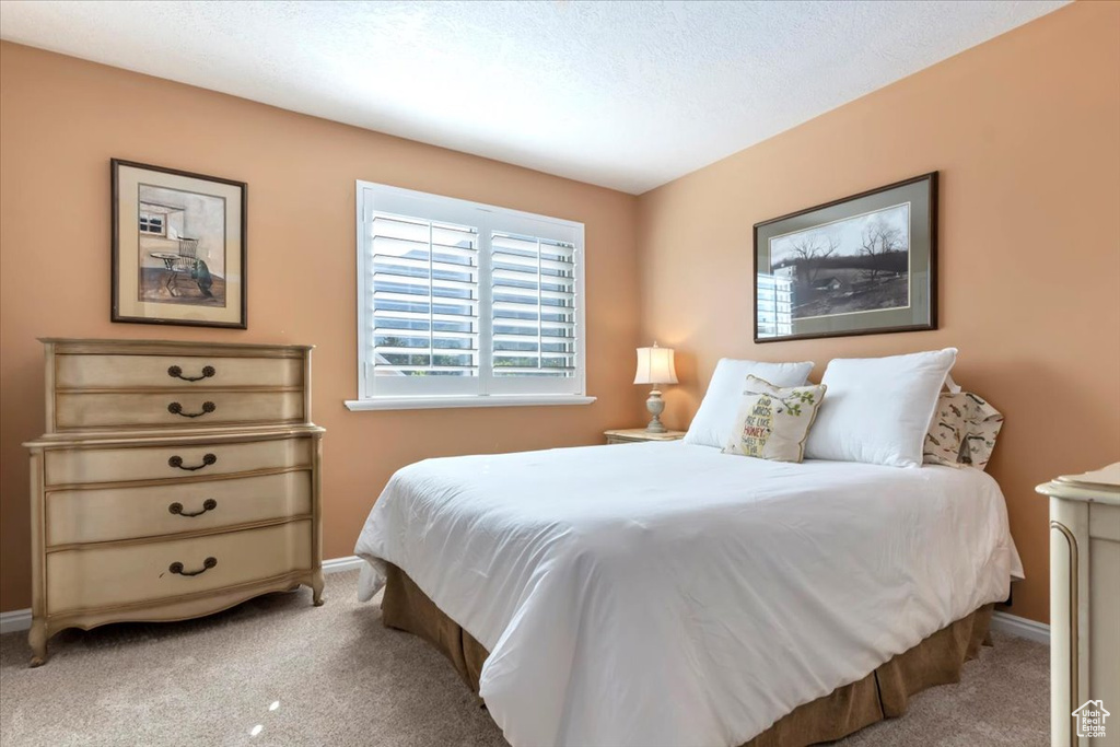 Carpeted bedroom featuring baseboards
