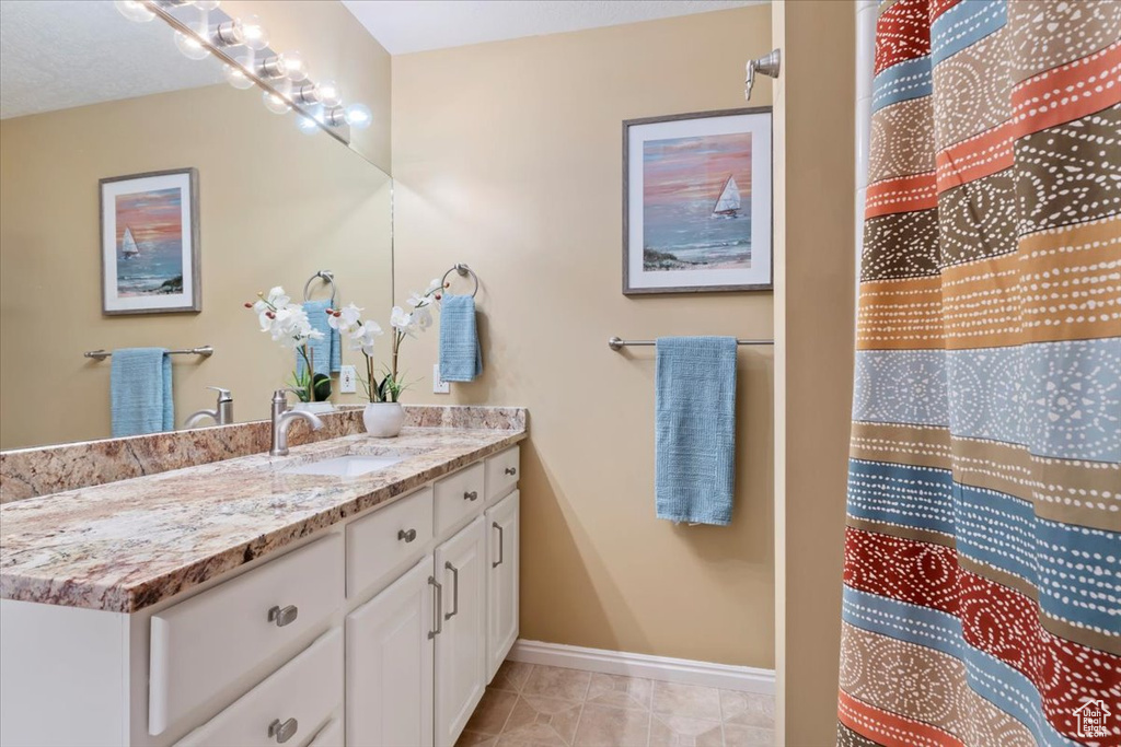 Full bathroom featuring vanity and tile patterned floors