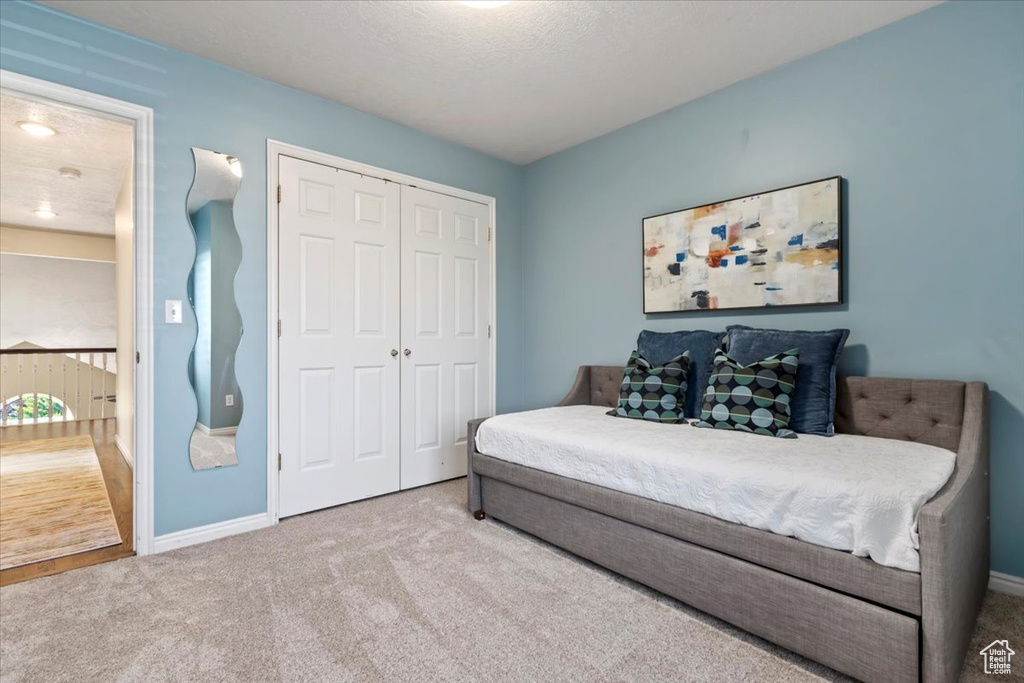 Bedroom with carpet and a closet