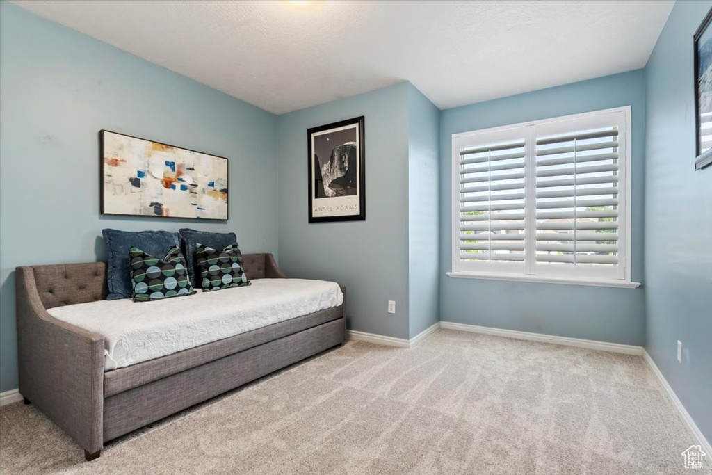 Carpeted bedroom with baseboards