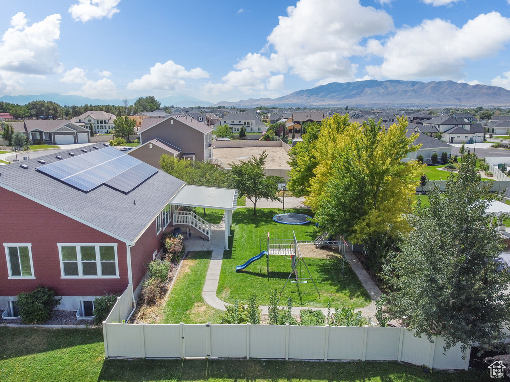 Aerial view of residential area featuring a mountainous background