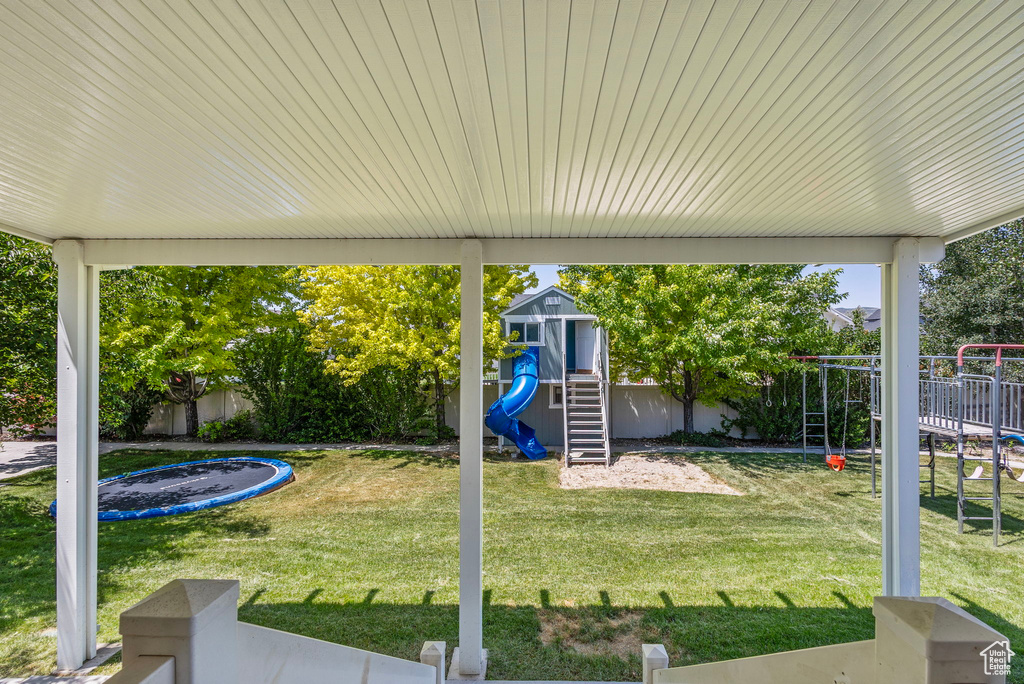 Fenced backyard with a playground