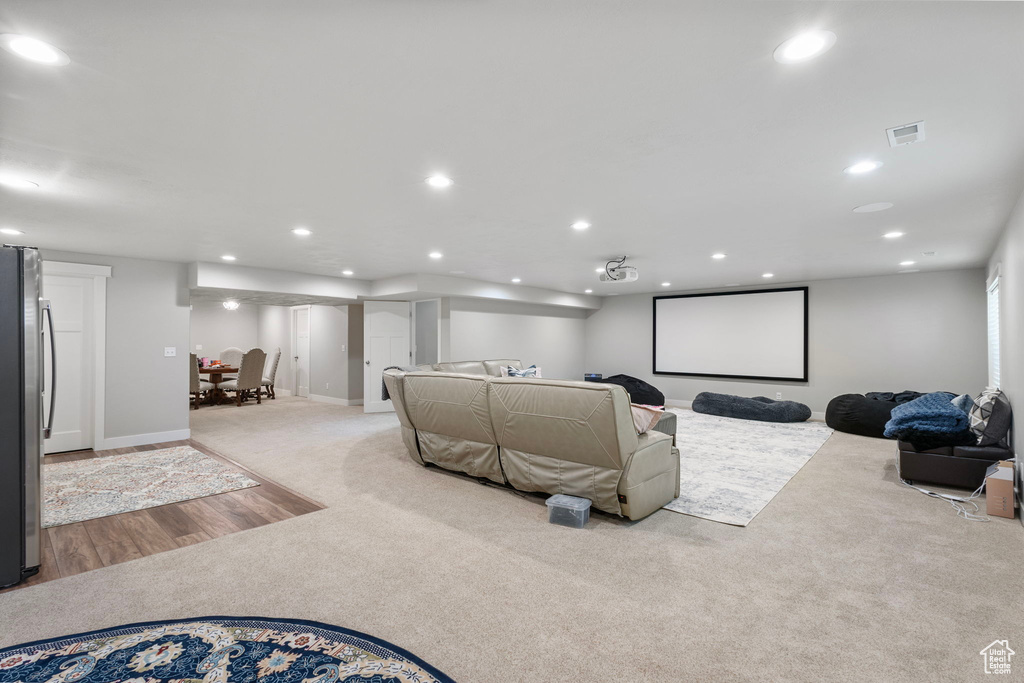 Home theater room featuring light carpet and recessed lighting
