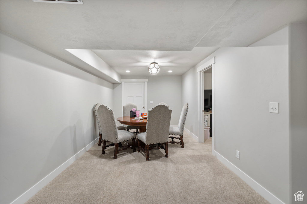 Dining room with carpet flooring and recessed lighting