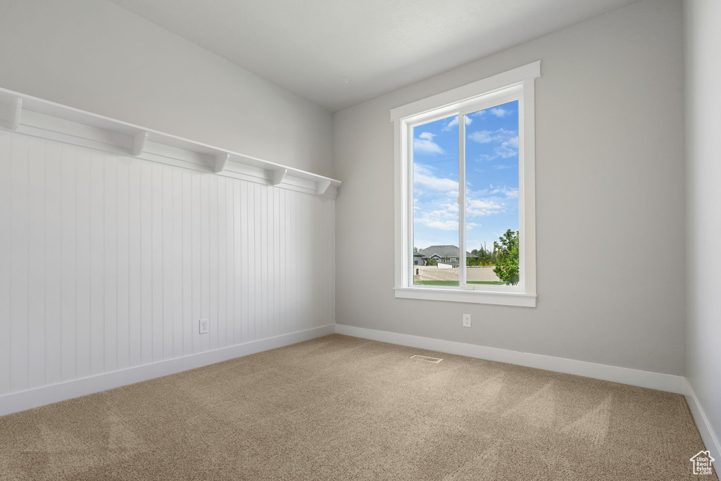 Unfurnished room with carpet floors and baseboards