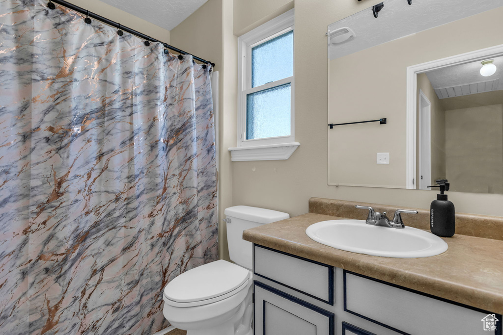 Full bathroom featuring vanity and a shower with shower curtain