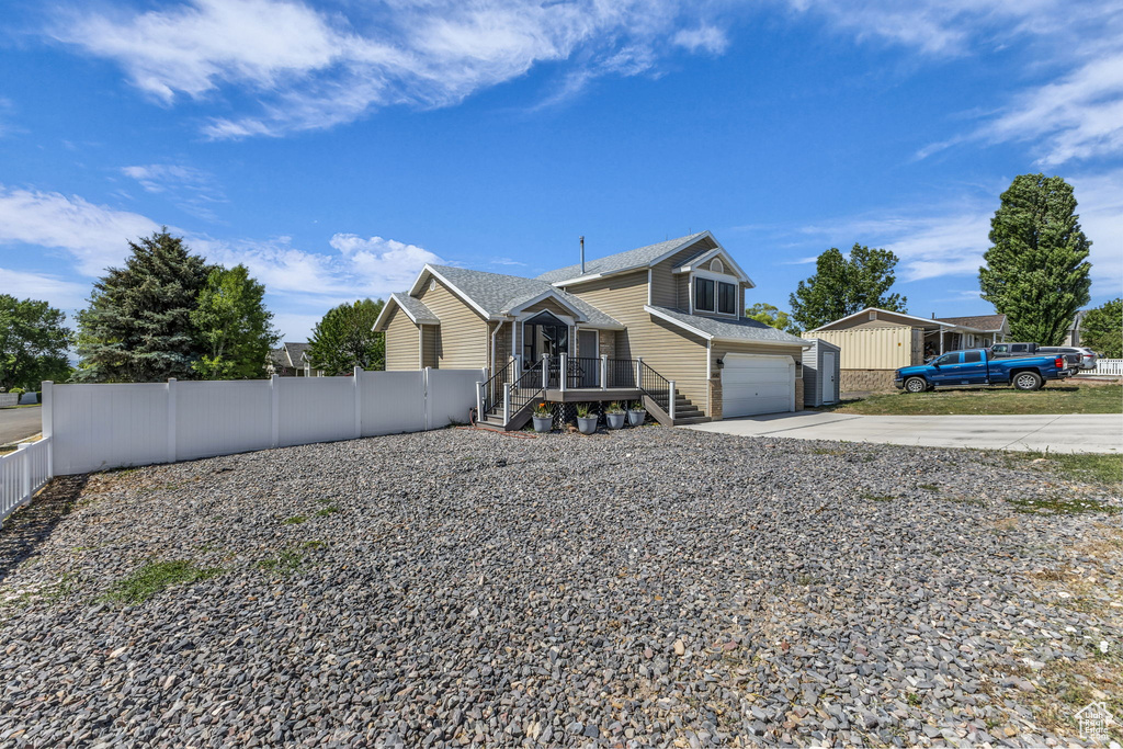 View of front facade featuring concrete driveway and an attached garage