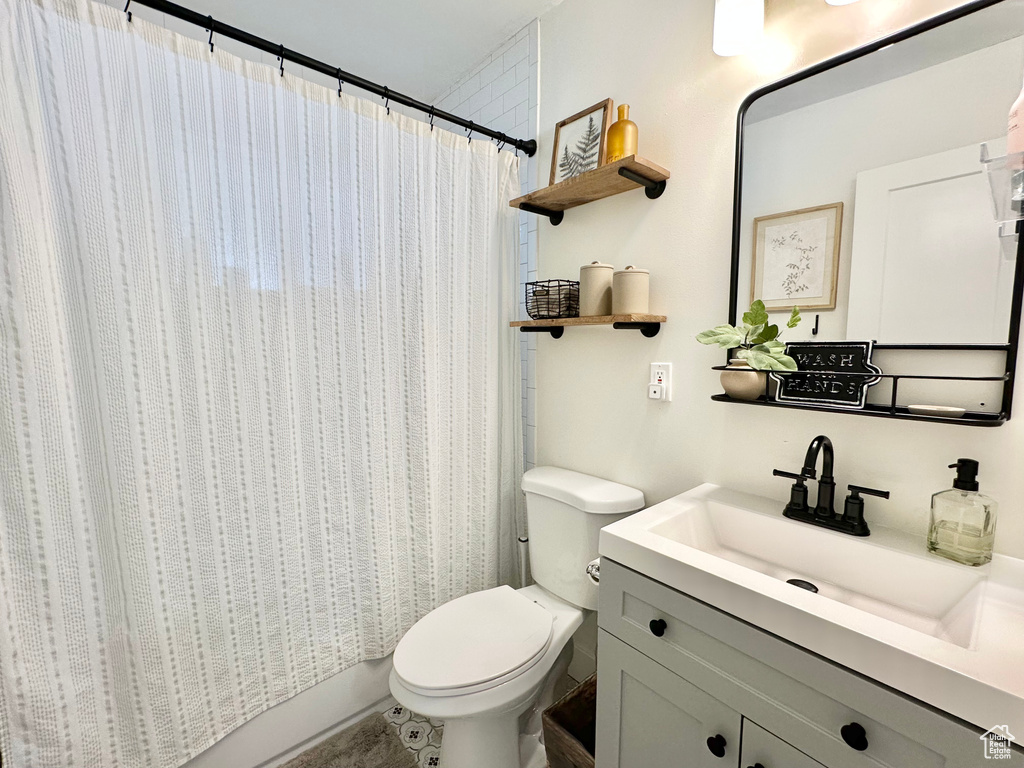 Full bathroom featuring toilet and vanity
