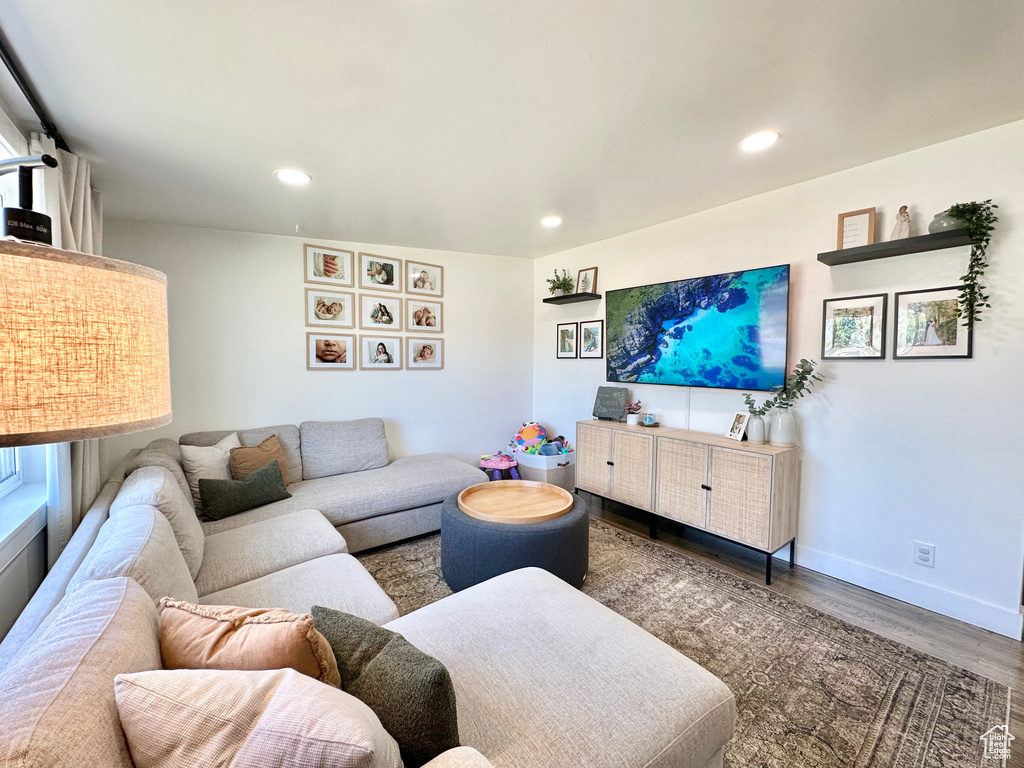 Living room with wood finished floors and recessed lighting