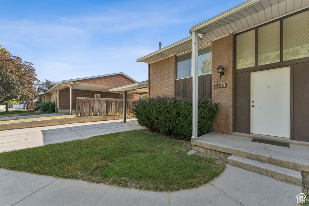 Doorway to property with brick siding