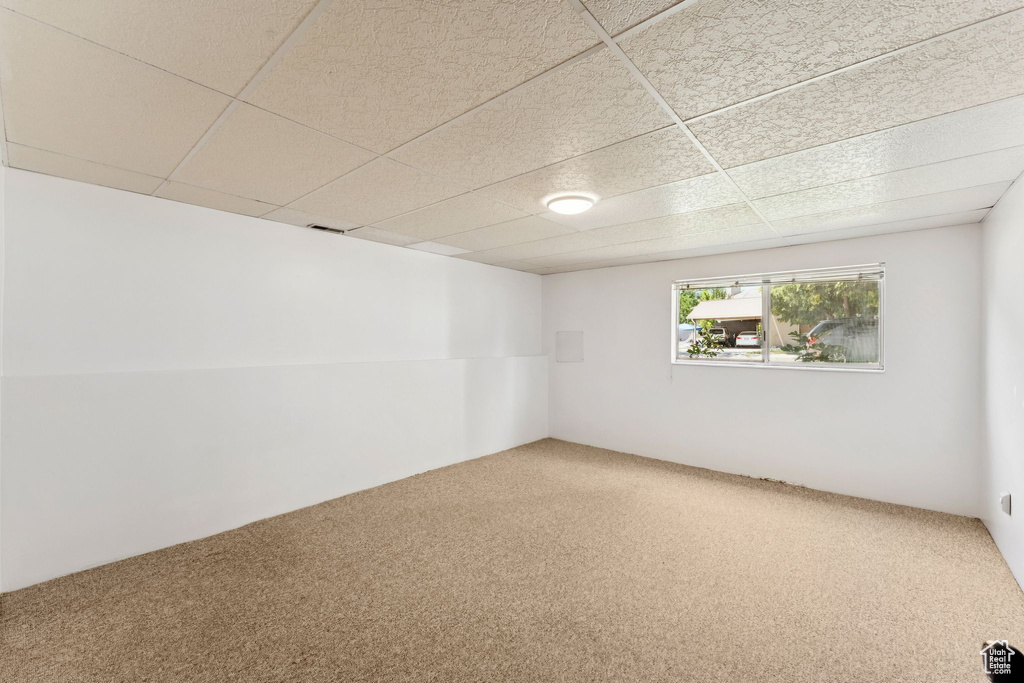 Carpeted empty room with a drop ceiling