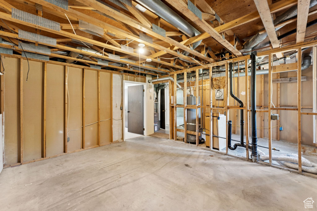 Unfinished basement featuring gas water heater