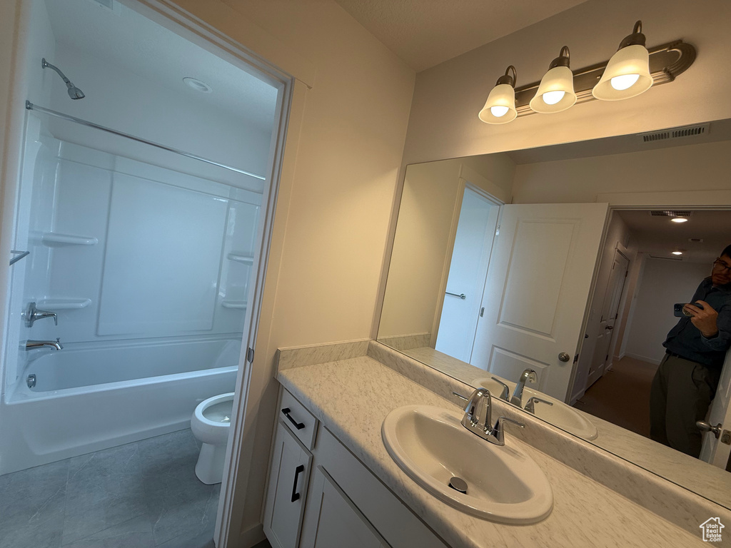 Bathroom with vanity, bathtub / shower combination, and tile patterned flooring