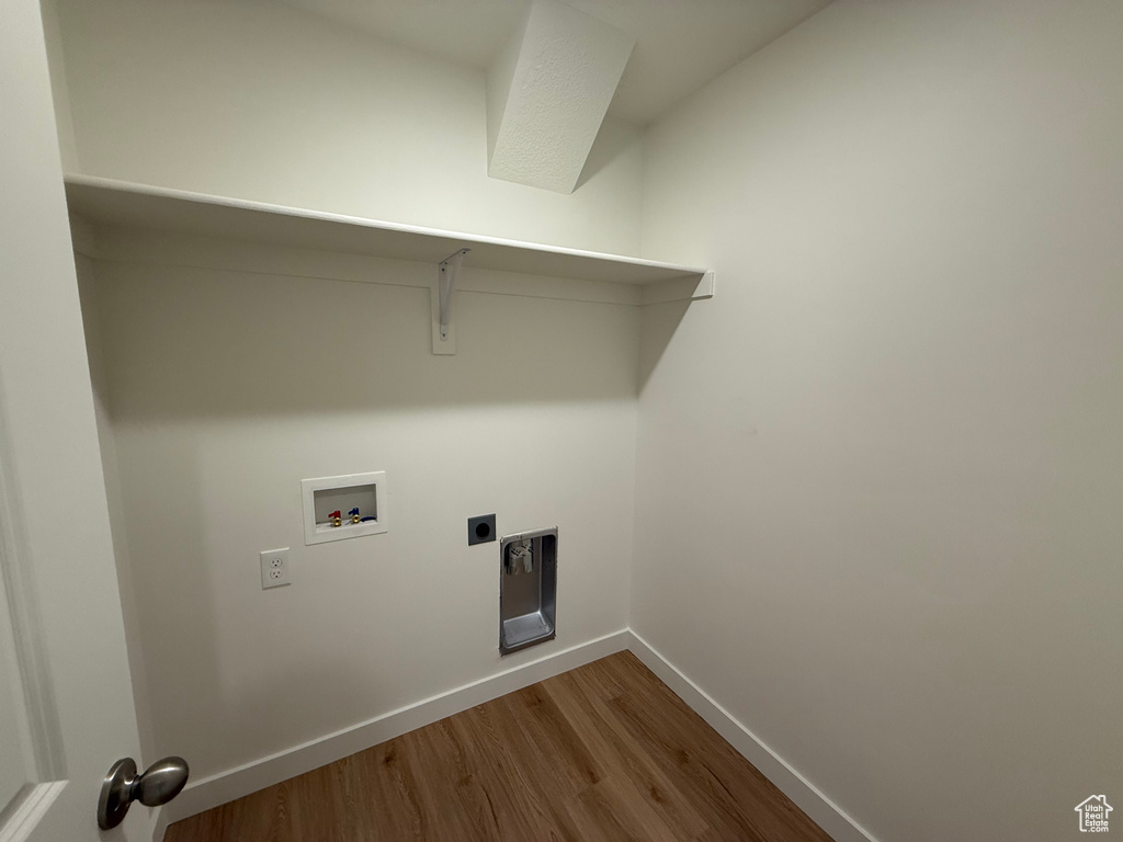 Laundry area featuring hookup for a washing machine, dark wood finished floors, and electric dryer hookup