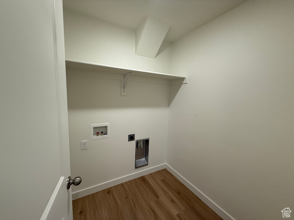 Laundry room with wood finished floors, washer hookup, and hookup for an electric dryer