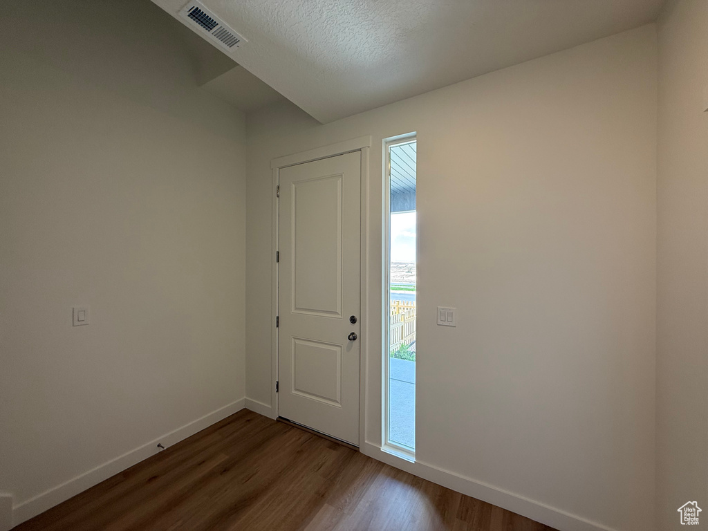 Foyer featuring dark wood finished floors and a textured ceiling