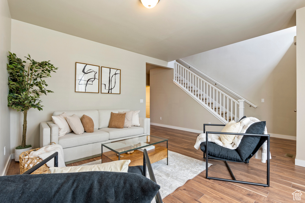 Living room featuring stairs and wood finished floors