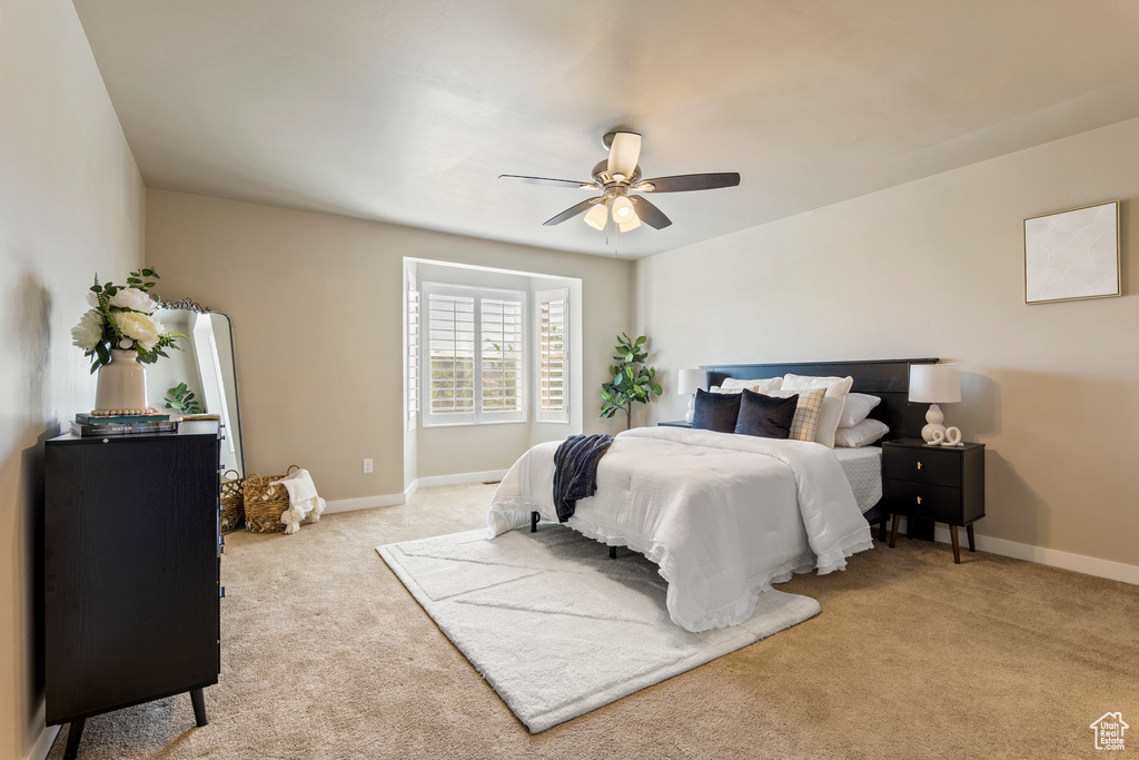 Bedroom featuring light carpet and ceiling fan