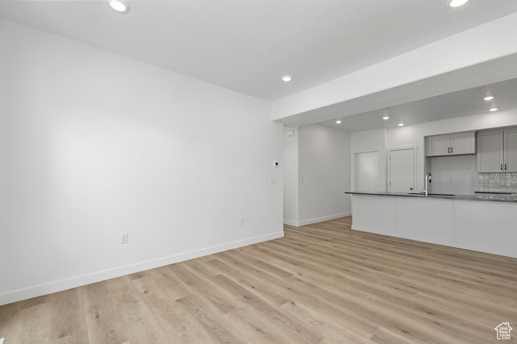 Unfurnished living room featuring recessed lighting and light wood-style floors