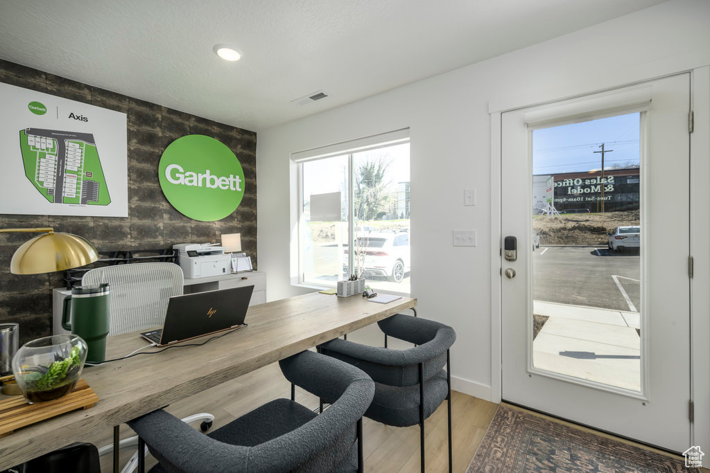 Office area with an accent wall, wood finished floors, and recessed lighting