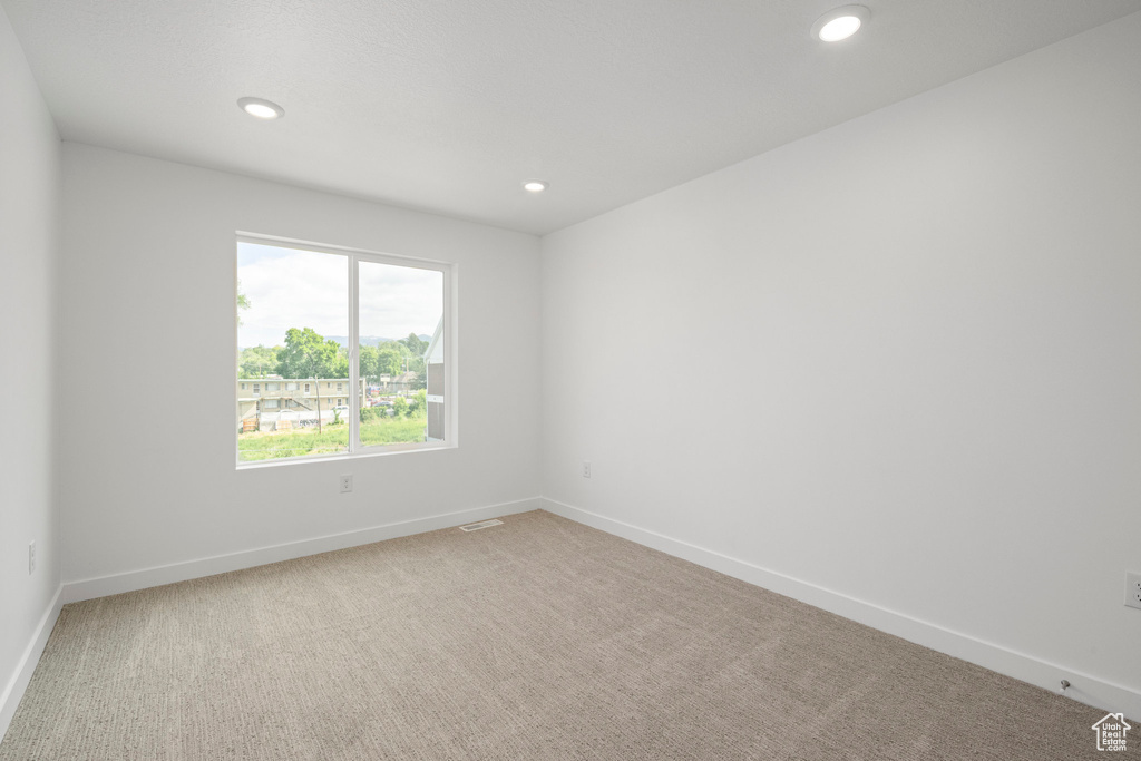 Empty room with carpet floors and recessed lighting