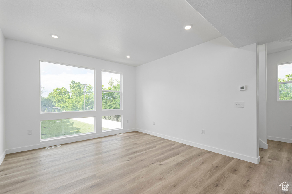 Spare room featuring light wood-type flooring and recessed lighting