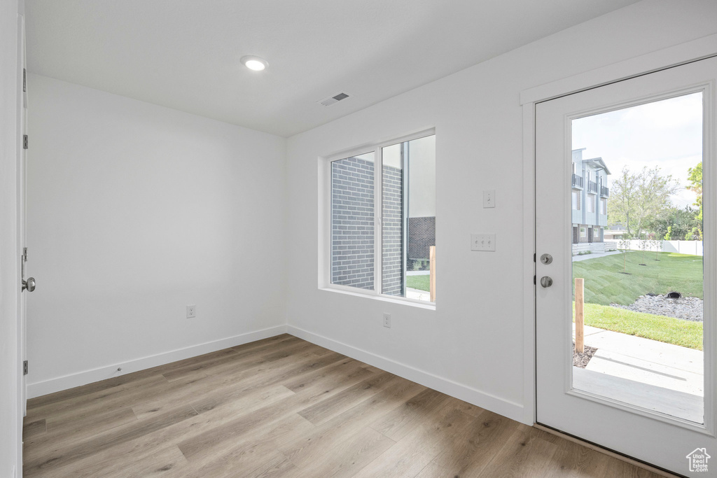 Entrance foyer with plenty of natural light, light wood-style floors, and recessed lighting