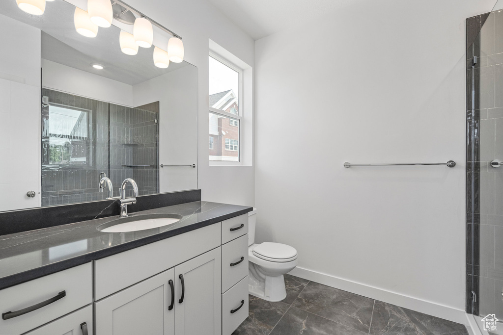 Full bathroom featuring vanity and tiled shower