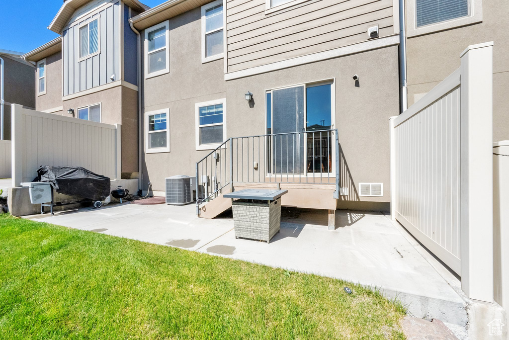 Back of property with a patio area, stucco siding, and a yard