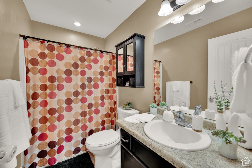 Full bath with vanity and a shower with curtain