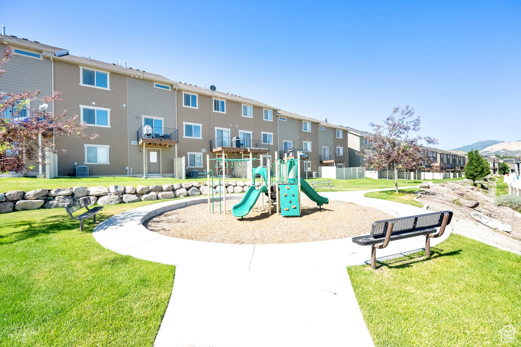 Community jungle gym featuring a yard and a residential view