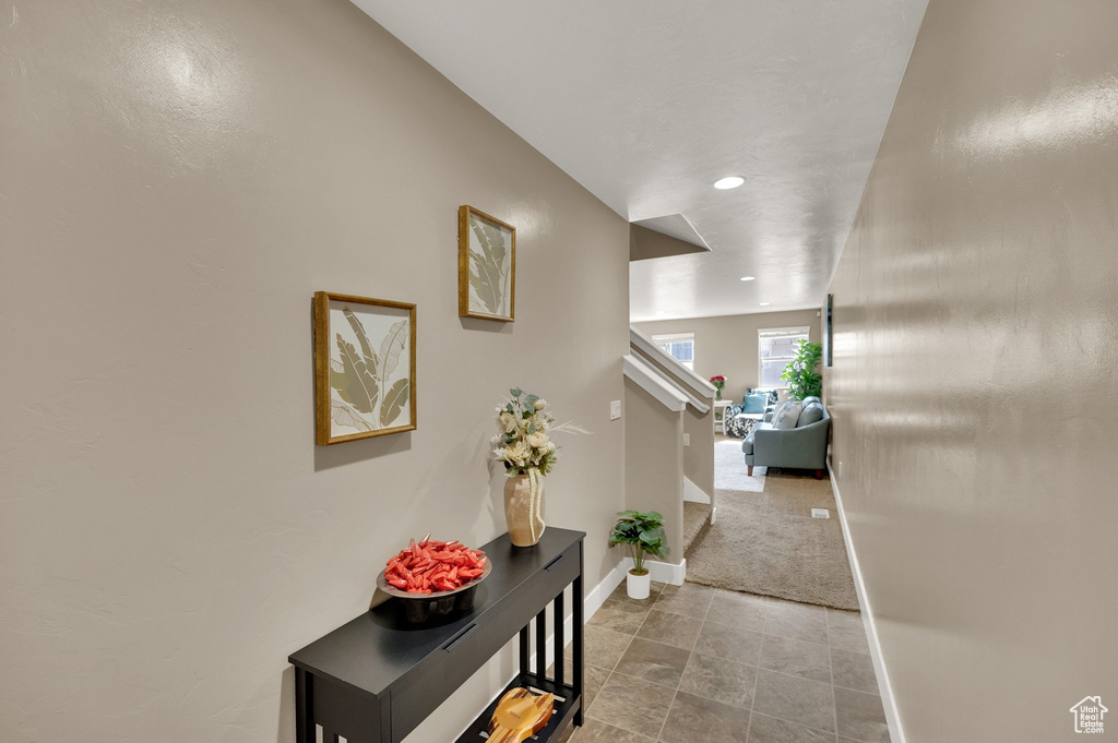 Hallway with baseboards and recessed lighting