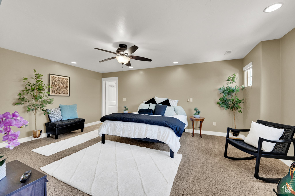 Carpeted bedroom with recessed lighting and a ceiling fan