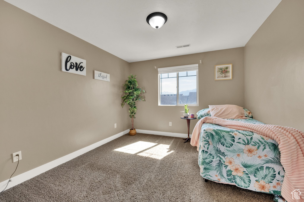 Carpeted bedroom with baseboards