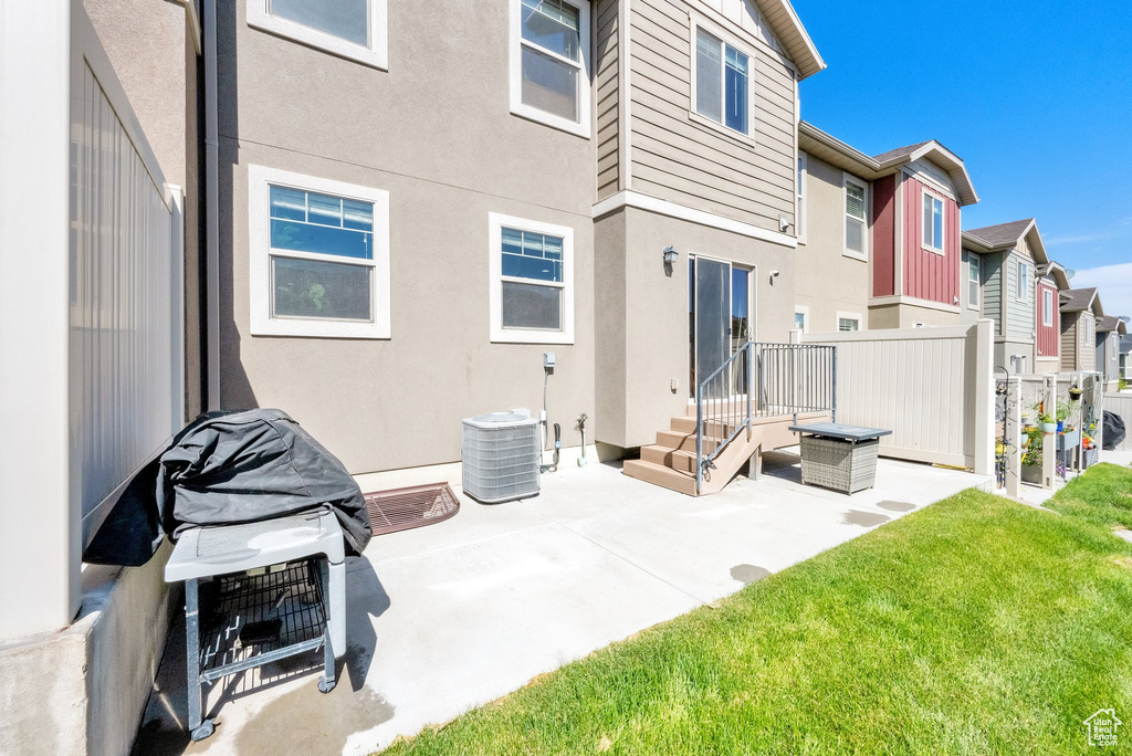Back of property featuring a residential view, a patio, and stucco siding