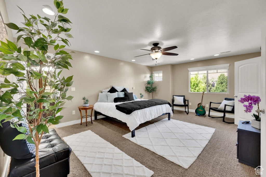 Carpeted bedroom featuring recessed lighting and a ceiling fan