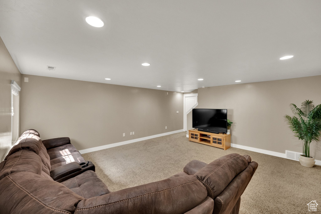 Carpeted living room with recessed lighting and baseboards