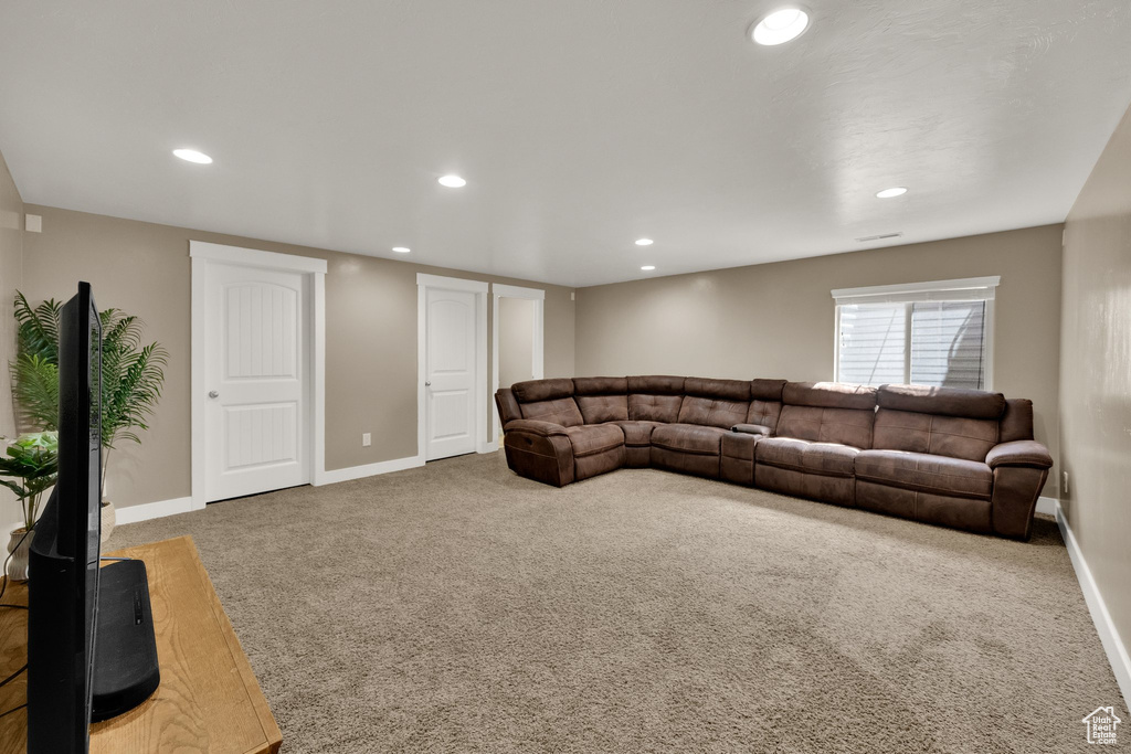 Living room with carpet flooring and recessed lighting