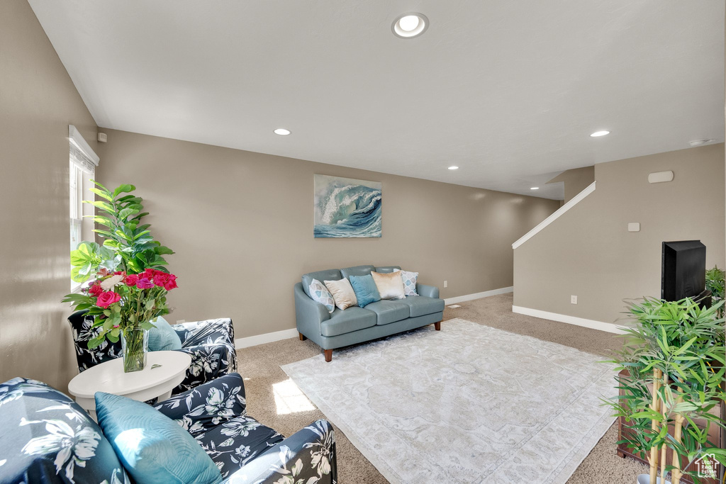 Living room featuring carpet floors, stairs, and recessed lighting