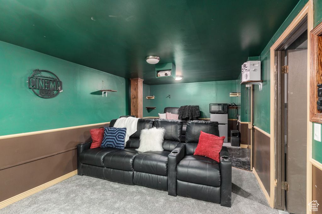 Cinema room with carpet and baseboards