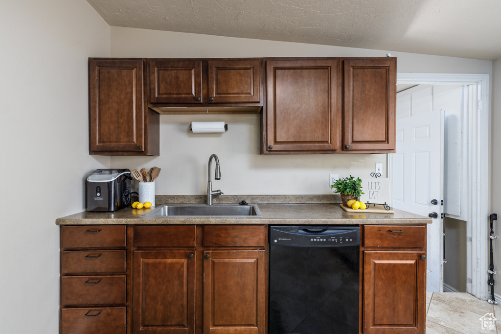 Kitchen with black dishwasher and lofted ceiling