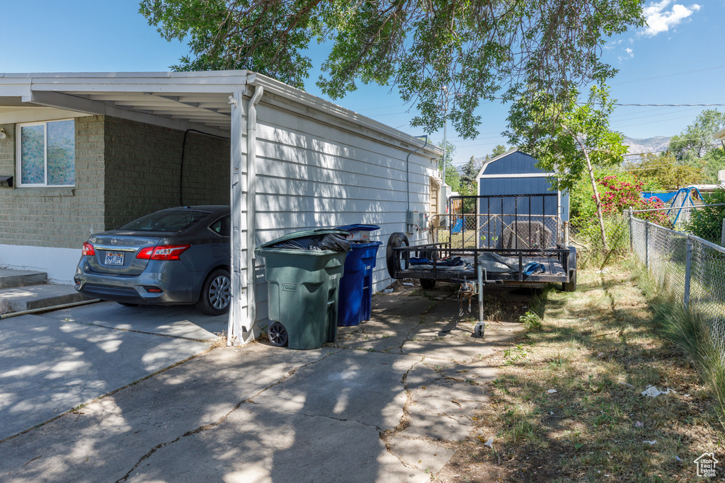 View of property exterior with a carport