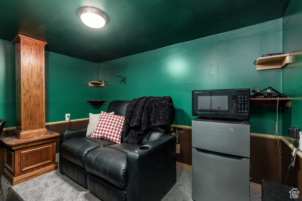 Home theater with carpet flooring and decorative columns