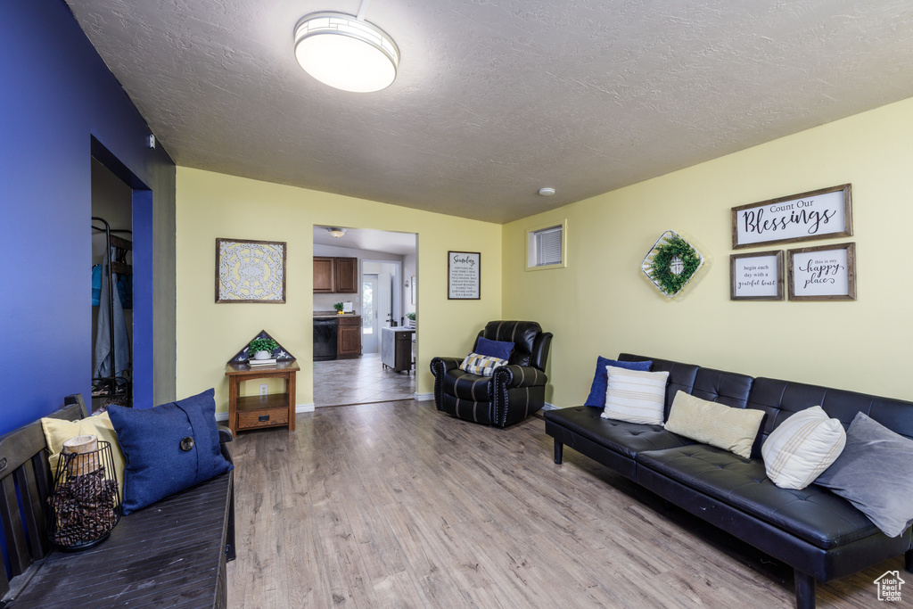 Living room featuring wood finished floors and a textured ceiling