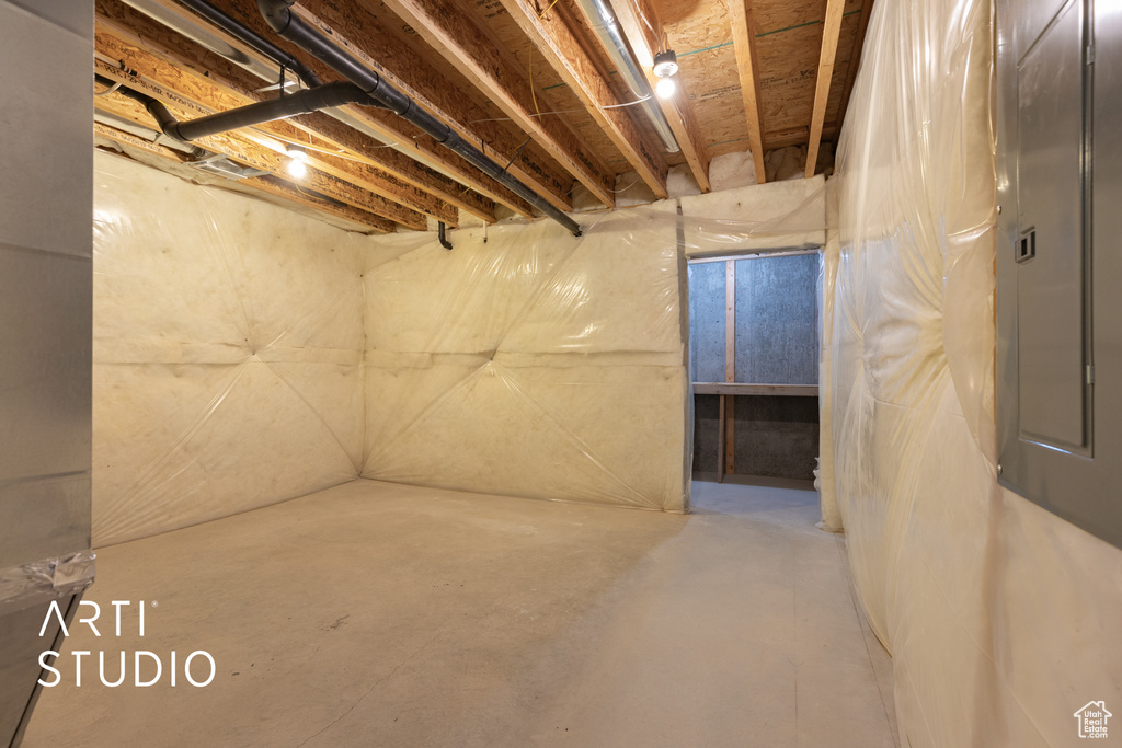 Unfinished basement featuring electric panel